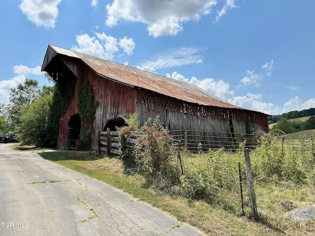 view of home's exterior featuring an outbuilding