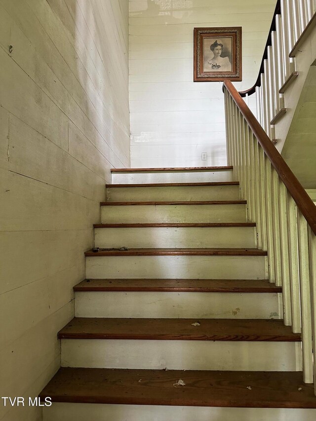 stairway with wood walls