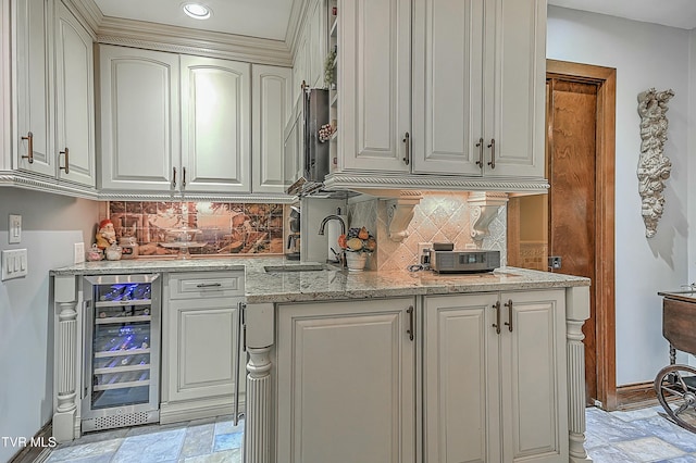 kitchen featuring sink, decorative backsplash, beverage cooler, and light stone counters