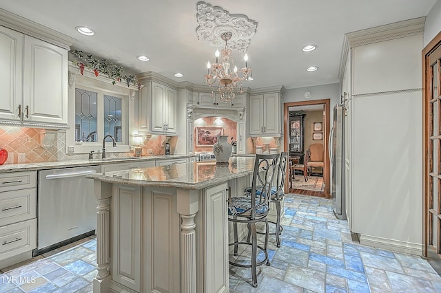 kitchen with tasteful backsplash, pendant lighting, a kitchen island, sink, and stainless steel appliances