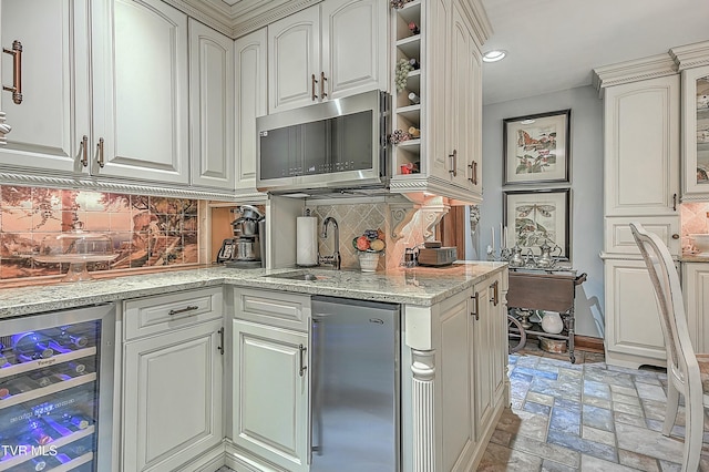 kitchen featuring white cabinetry, wine cooler, decorative backsplash, light stone counters, and fridge