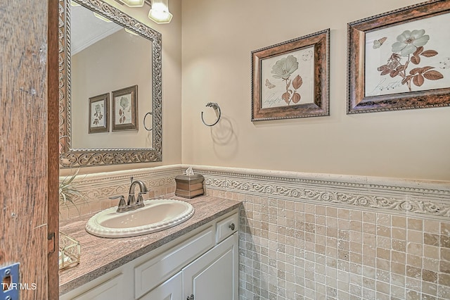 bathroom featuring tile walls, vanity, and ornamental molding