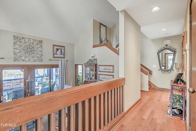 hall with vaulted ceiling, french doors, and light hardwood / wood-style floors