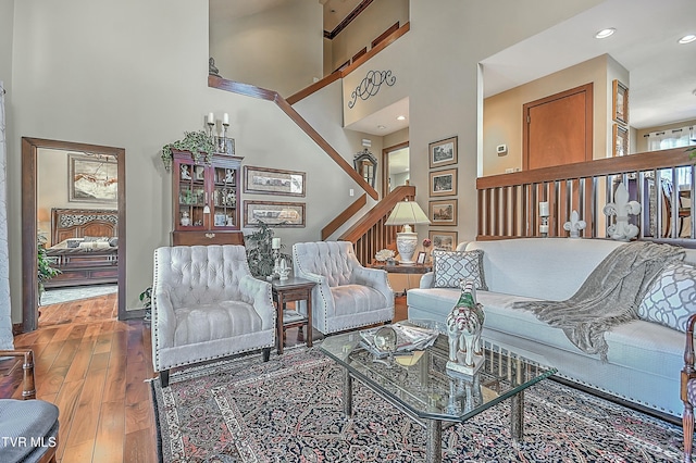 living room featuring a high ceiling and hardwood / wood-style floors