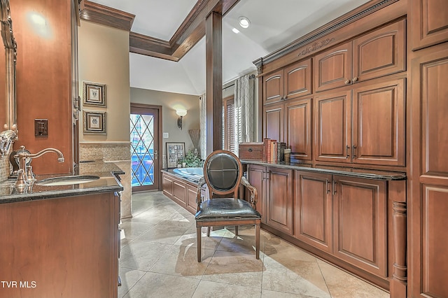 bathroom featuring a tub, crown molding, vanity, and tile patterned flooring