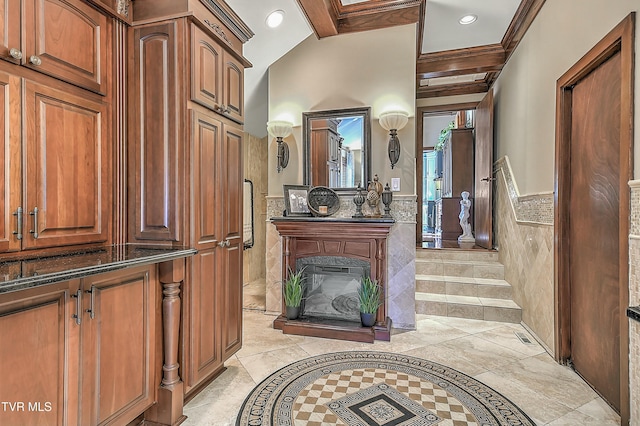 bathroom featuring tile walls, beamed ceiling, and ornamental molding