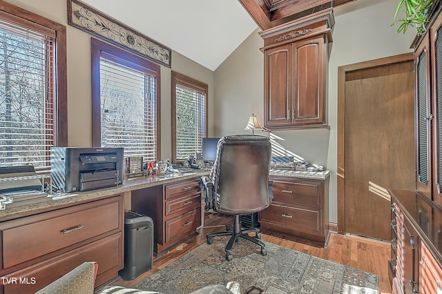 office area with vaulted ceiling and light hardwood / wood-style flooring