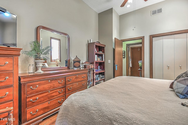 bedroom with ceiling fan, a closet, and high vaulted ceiling