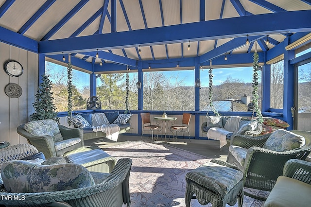 sunroom / solarium featuring lofted ceiling with beams