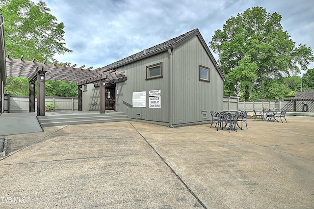 rear view of house with a pergola and a patio