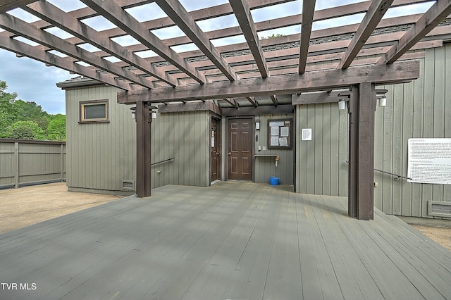 exterior space featuring a skylight, light hardwood / wood-style floors, and wood walls