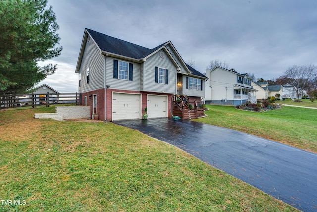 view of front of home with a garage and a front lawn