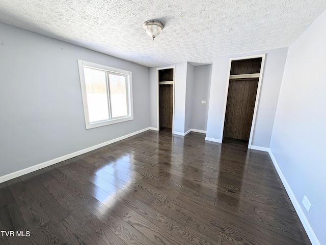 unfurnished bedroom featuring dark wood-type flooring and a textured ceiling