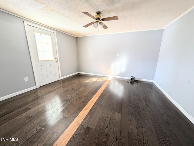 spare room with a textured ceiling, dark wood-type flooring, and ceiling fan