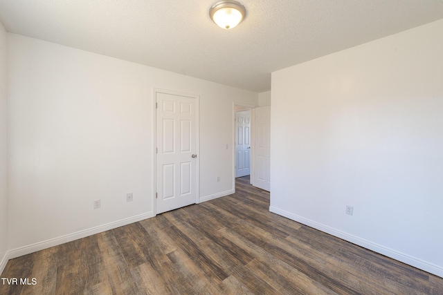 empty room featuring dark wood-type flooring