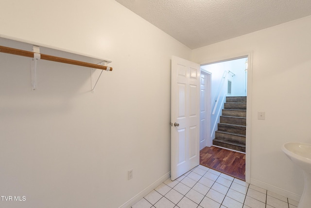 interior space featuring a textured ceiling and tile patterned floors