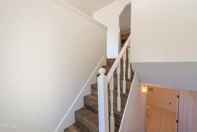 staircase with tile patterned floors