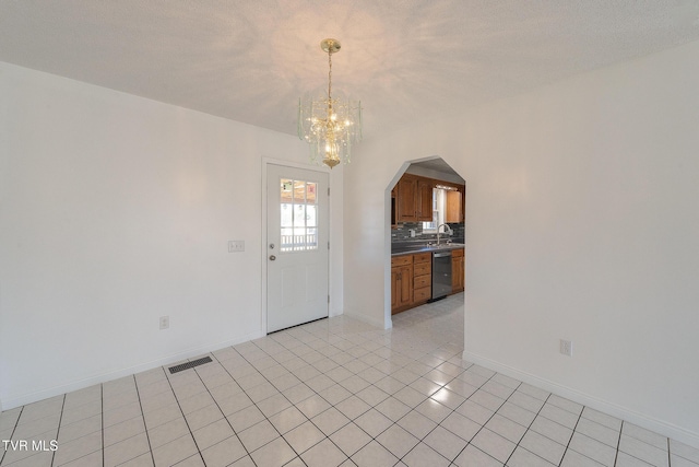 interior space featuring a notable chandelier, sink, and a textured ceiling