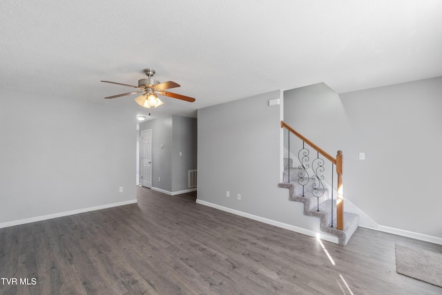 spare room featuring ceiling fan, a textured ceiling, and dark hardwood / wood-style flooring