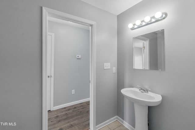 bathroom featuring sink and a textured ceiling