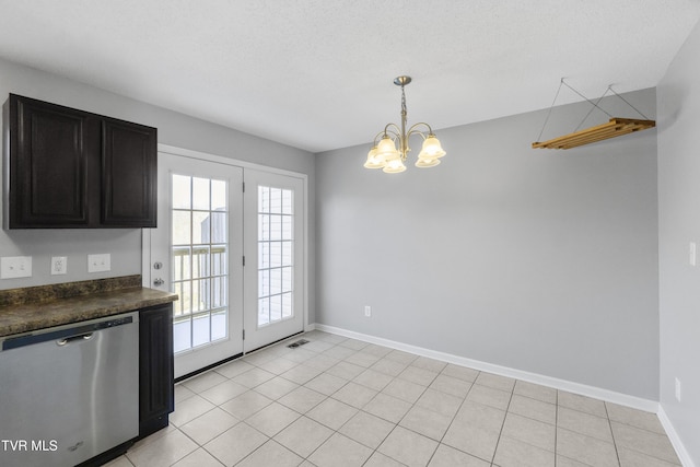 kitchen featuring pendant lighting, stainless steel dishwasher, light tile patterned flooring, a textured ceiling, and a chandelier