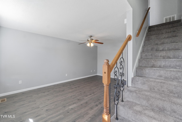 stairway with ceiling fan and hardwood / wood-style floors