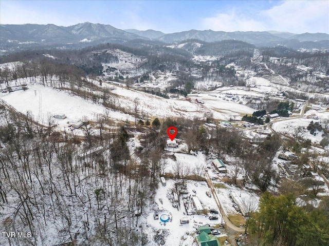 snowy aerial view featuring a mountain view