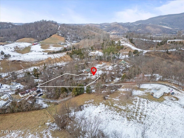 snowy aerial view featuring a mountain view