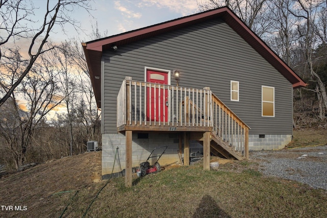 back house at dusk with central air condition unit