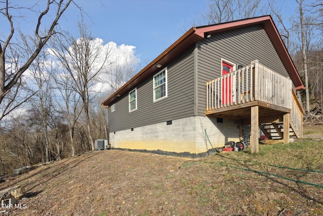 view of property exterior featuring central air condition unit and a deck