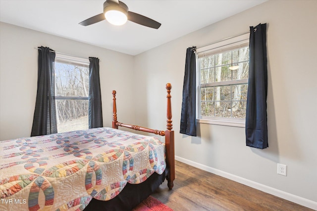 bedroom with ceiling fan and dark hardwood / wood-style floors