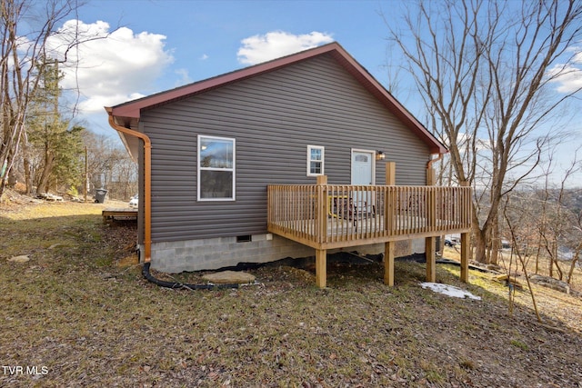 back of property with a wooden deck