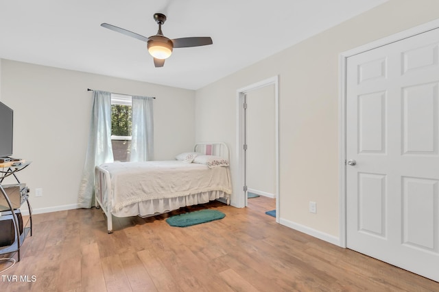 bedroom with ceiling fan and light hardwood / wood-style floors