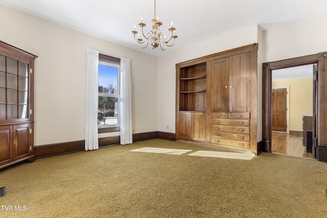 interior space with carpet floors and an inviting chandelier