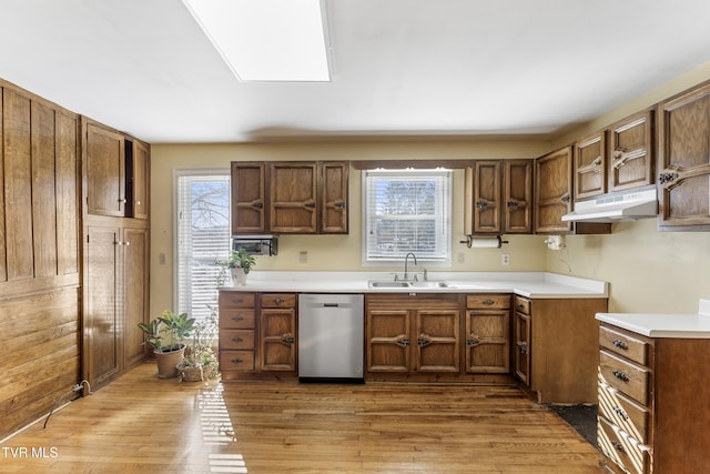 kitchen with light wood-type flooring, dishwasher, and sink