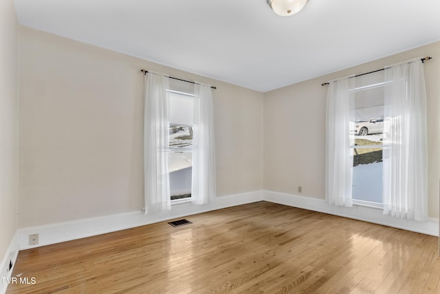 empty room with hardwood / wood-style flooring