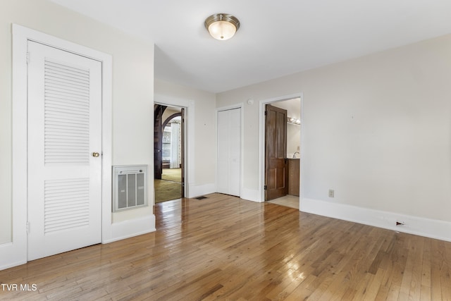 interior space featuring connected bathroom and hardwood / wood-style floors