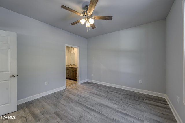 unfurnished room with ceiling fan and light wood-type flooring