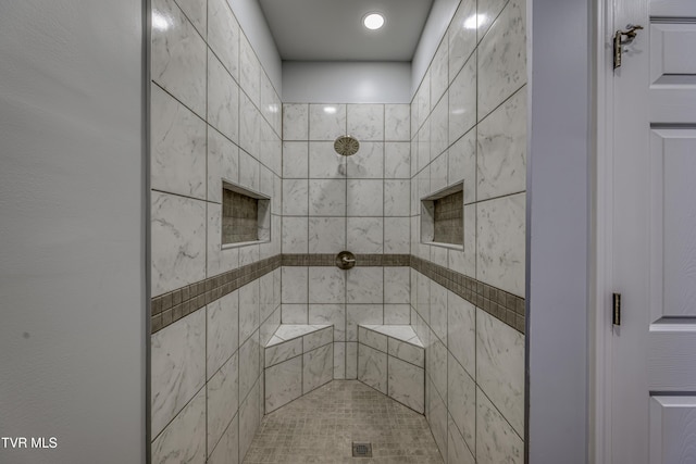 bathroom featuring a tile shower