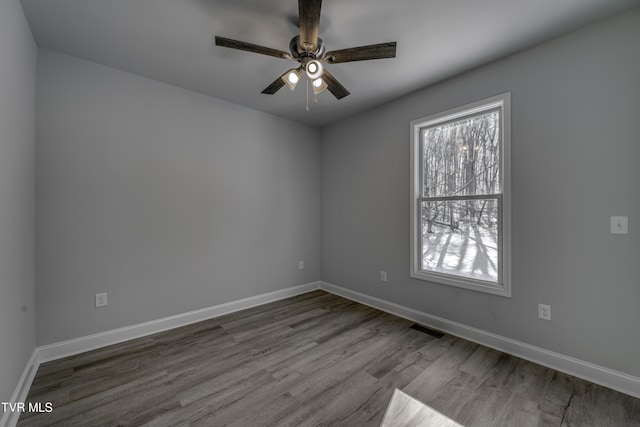 unfurnished room with ceiling fan and hardwood / wood-style floors