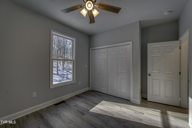 unfurnished bedroom with ceiling fan, light hardwood / wood-style floors, and a closet