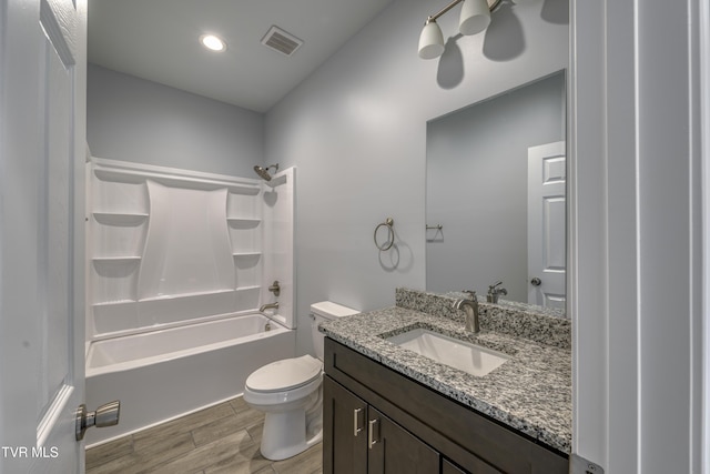 full bathroom with vanity, hardwood / wood-style flooring, toilet, and shower / bath combination