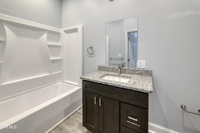 bathroom featuring vanity and  shower combination