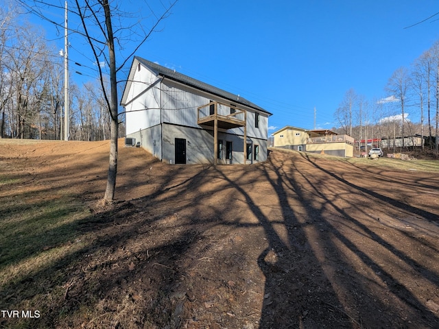 rear view of property featuring a wooden deck