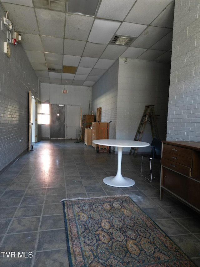 hallway featuring a paneled ceiling