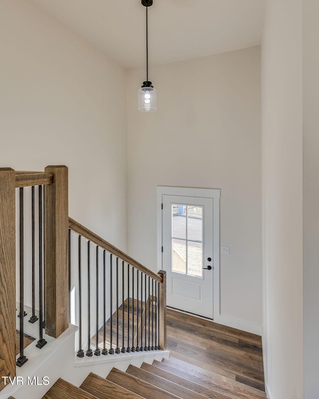 entryway featuring wood finished floors and baseboards