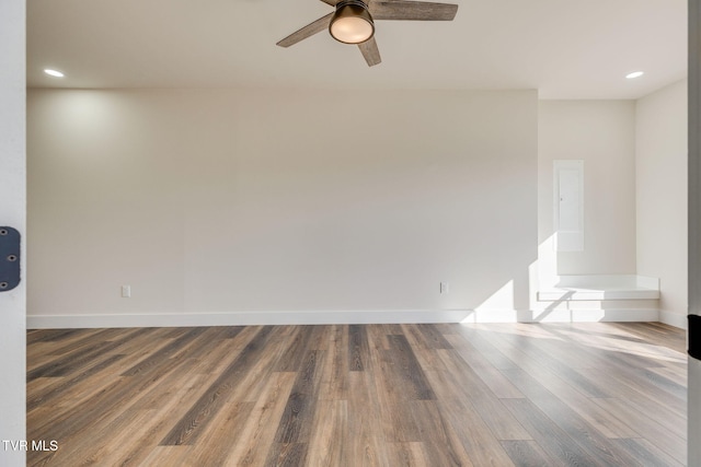 unfurnished room featuring recessed lighting, ceiling fan, baseboards, and wood finished floors