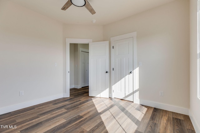 unfurnished bedroom featuring a ceiling fan, baseboards, and wood finished floors