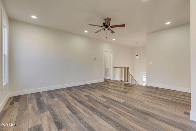 spare room featuring visible vents, recessed lighting, wood finished floors, and baseboards