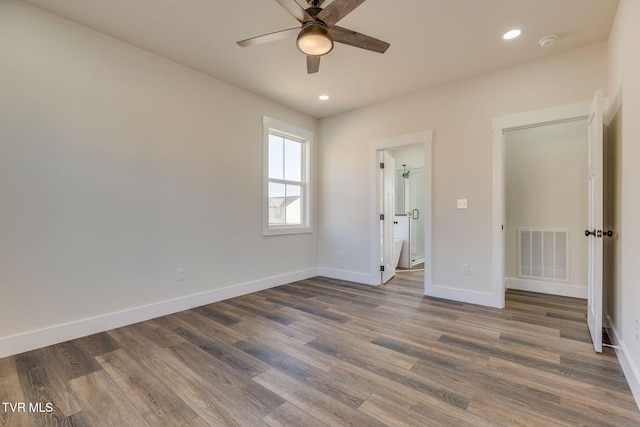 unfurnished bedroom featuring wood finished floors, recessed lighting, baseboards, and visible vents